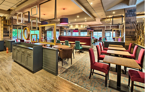 Modern dim lit restaurant with wooden and carpet flooring that is fitted with double stick systems