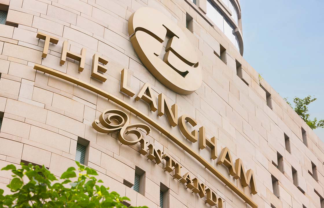 The gold sign of the Langham Hotel Shanghai China on the side of the hotel