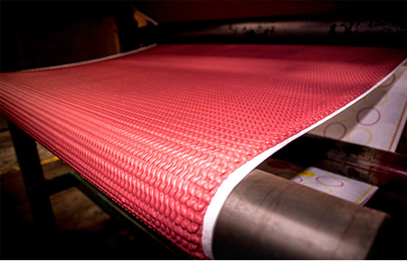 A sponge rubber underlay being made by a machine